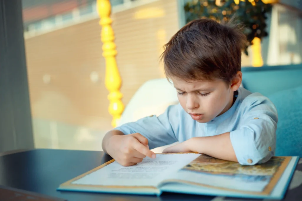 child experiencing difficulty reading book